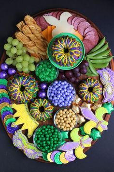 a platter filled with lots of different types of food on top of a table