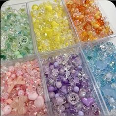 many different colors of beads in plastic containers