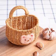 a basket with a stuffed animal inside and garlic on the side, next to it