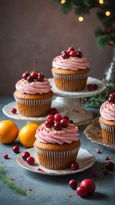 cupcakes with frosting and cranberries on plates