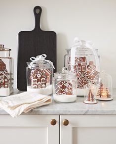 the kitchen counter is decorated with gingerbread cookies and other holiday decorating items on it