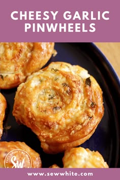 cheesy garlic pinwheels on a black plate with text overlay that says,