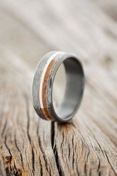 a wedding ring with wood and silver inlays