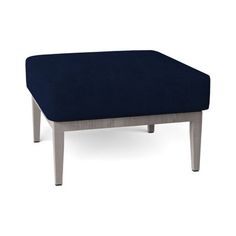 a blue ottoman sitting on top of a wooden table