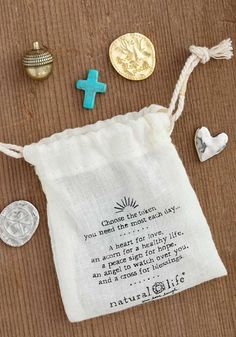 a bag with some beads and other items on it next to a coin that says, choose the path you need in each day