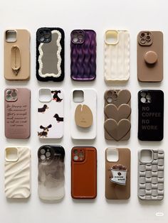 there are many different cell phones on the white surface, each with a phone case attached to it