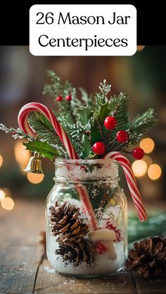 A mason jar centerpiece decorated with Epsom salt, pinecones, holly, bells, and candy canes for a winter wedding. Mason Jars Christmas Centerpieces, Winter Decor Table Centerpiece Ideas, Silver Table Decorations Christmas, Christmas Candy Jars Decoration, Pine Cone Christmas Table Centrepiece, Diy Candy Cane Centerpiece, Mason Jar Epsom Salt Christmas, Christmas Mason Jar With Fairy Lights, Christmas Decor With Mason Jars