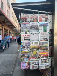 a newspaper stand on the side of a street