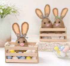 two wooden boxes filled with easter eggs and stuffed bunnies in the shape of rabbits