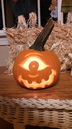 a carved pumpkin sitting on top of a wooden table