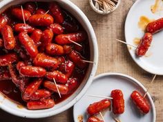 hot dogs are being cooked on skewers with toothpicks in a bowl