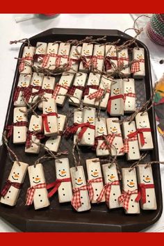 snowmen made out of marshmallows on a tray with twine string