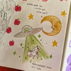 an open book with drawings on it and writing about the moon, stars, and other things