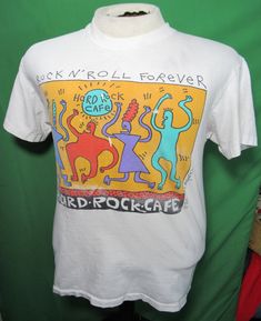 "Great Rare Original 1992 Hard Rock Cafe T-Shirt with Keith Haring-esq / Pop Art Character Design. The shirt has a good deal of wear including paint stains and some other general staining and wear to the graphic. It overall has a great thrashed look and does not have damage such as holes and is very much intact. Size tag is Medium but vintage sizing varies, be sure to check measurements below to ensure proper fit. Measurements: Pit to Pit (Chest): 18\" Top of Shoulder to Bottom: 25\"" Black Leather Combat Boots, Retro Tee, Hard Rock Cafe, Keith Haring, Paint Stain, Cool Boots, Hard Rock, Pop Art, Shirt Designs