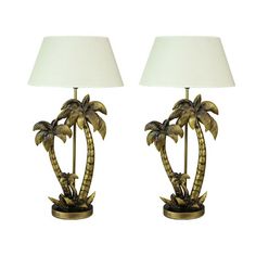 a pair of lamps with palm trees on them