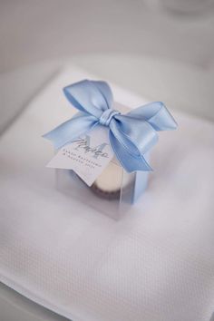 a small white box with a blue bow on it