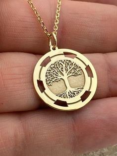 "Dainty 14k Solid Gold Tree of life Necklace, Gold Tree Necklace, Custom Tree of life necklace, Personalized  Gold Tree Of Life Necklace 14k Solid Gold Choose What Size You Want the Pendant Using The First Option Box Choose Chain Length Or Without Chain Using The Second Option Box Photos Are For The 20mm / 0.78 inch Diameter Pendant Pendant thickness : 0.7mm  Contact us if you want it thicker Inner diameter of jump ring : 5mm Contact us if you need it bigger  Chain width : 1.30mm     ♥  Material of pendant and chain: Solid Gold k14  ♥  Packaging: All of our jewelry are beautifully boxed and ready for gifting For more personalized designs take a look here: ♥ www.etsy.com/listing/736955132 ♥ www.etsy.com/listing/819494857 ♥ www.etsy.com/listing/823397880 ♥ www.etsy.com/listing/769847320 ♥ ww Golden Tree Necklace, Yellow Gold Tree Of Life Pendant Jewelry, 14k Gold Tree Of Life Pendant Jewelry, Sterling Silver Yellow Gold Tree Of Life Necklace, Yellow Gold Sterling Silver Tree Of Life Necklace, Tree Of Life Round Jewelry For Anniversary, Tree Of Life Round Pendant Jewelry For Anniversary, Symbolic Gold Jewelry With Tree Of Life, 14k Yellow Gold Tree Of Life Jewelry