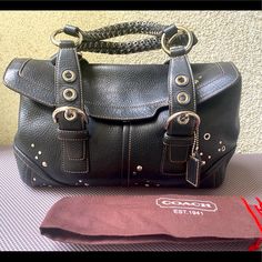 This Is A Rare Limited Edition Coach Studded Flap Satchel, Style No. 10933. Gorgeously Crafted, It Is Water And Stain Resistant Crafted In Luxurious Black Leather With Awesome Stud Details And Stunning Braided Handles! Complete With Coach Embossed Leather Hang Tag, Absolutely Fabulous And One Of A Kind! This Is Sold Out Everywhere And Extremely Hard To Find Online. In Fact You Hardly See One Like It Anywhere. This Is One Of The Coach Satchel You Will Surely Love To Have And Do Not Want To Miss. It Is Valued Over $500 With Tax Included. This Is Brand New, Never Worn, But I Am Missing The Tags. This Bag Will Make A Great Statement And Sure To Turn Heads! Beautiful Iconic Details That Will Las Silver Coach Leather Shoulder Bag, Coach Satchel, Absolutely Fabulous, Coach Bags, Limited Editions, Black Fabric, Embossed Leather, Black Silver, Dust Bag