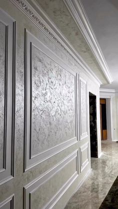 an empty room with white walls and marble floors