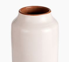 a white vase with a brown rim is shown