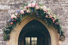 an arched doorway with flowers on it