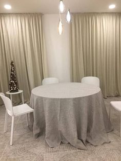 a round table with white chairs around it