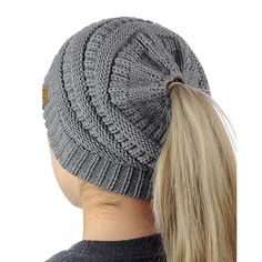 a woman's ponytail wearing a gray knitted beanie with a button on the side