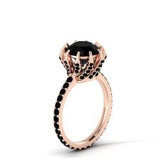 a black diamond engagement ring with an oval center stone surrounded by small black diamonds in rose gold