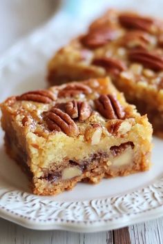 two pieces of pecan pie on a white plate