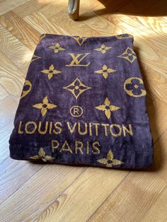 the louis vuitton paris blanket is on the floor