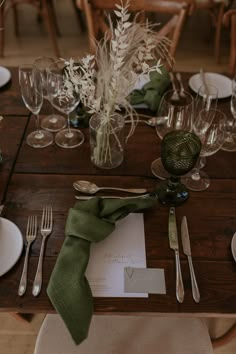 the table is set with silverware and place settings