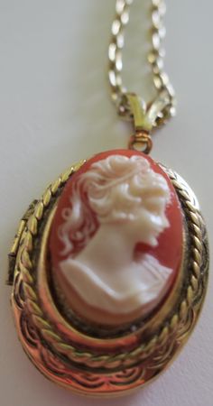 This is a vintage gold tone cameo locket/pendant.  16" long chain and the locket is about .5 inches wide and 1" long.  Preowned Cameo Locket, Vintage Cameo, Mesa Az, Locket Necklace, Long Chain, Vintage Gold, Locket, Gold Tones, Jewelry Necklaces