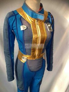 a blue and gold suit on display in front of a white backdrop with the words star trek