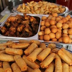 several trays filled with different types of food