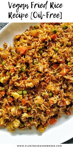 vegan fried rice with peas and carrots on a white plate