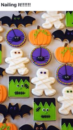 halloween decorated cookies are displayed on a table