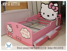 a pink hello kitty bed with drawers in the middle and an image of a hello kitty on it