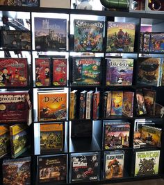 a display case filled with lots of video game titles and games on it's sides