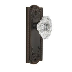 an antique style door handle with glass knob