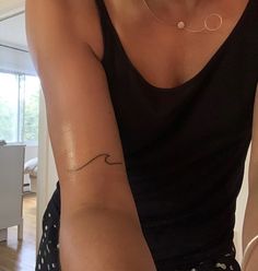 a woman with a small tattoo on her arm