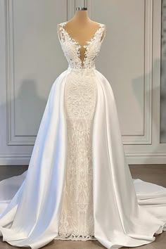 a white wedding dress on display in a room