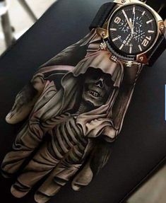 a glove with a skeleton on it sitting on top of a chair next to a watch