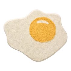 an egg is shown in the shape of a fried egg on a white surface with yellow highlights