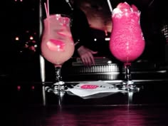 two drinks sitting on top of a table next to each other in front of a person