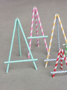 three paper straw easels sitting next to each other