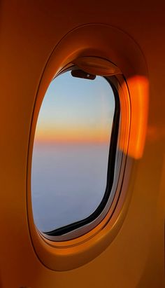 an airplane window looking out at the ocean