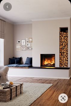 a living room filled with furniture and a fire place next to a window on top of a hard wood floor