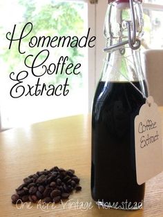 a bottle of coffee sitting on top of a wooden table next to a pile of coffee beans