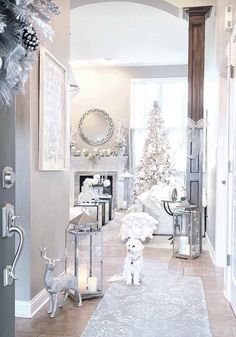 a white dog is standing in the middle of a hallway with christmas decorations on the walls