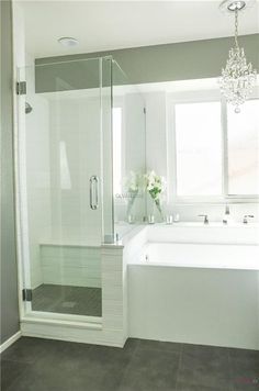 a bathroom with a tub, shower and sink